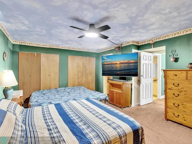 a bedroom with a bed and a flat tv screen