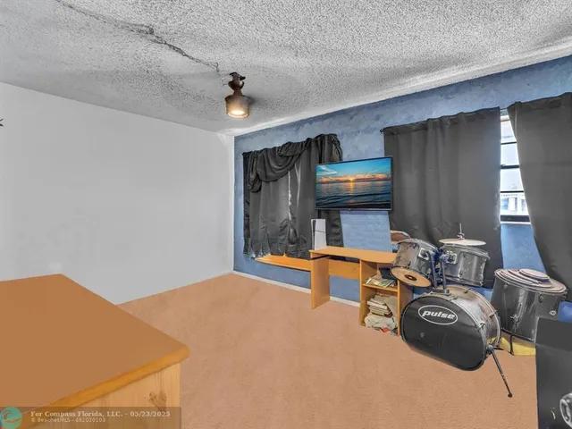 a bedroom with furniture and a air conditioner vent