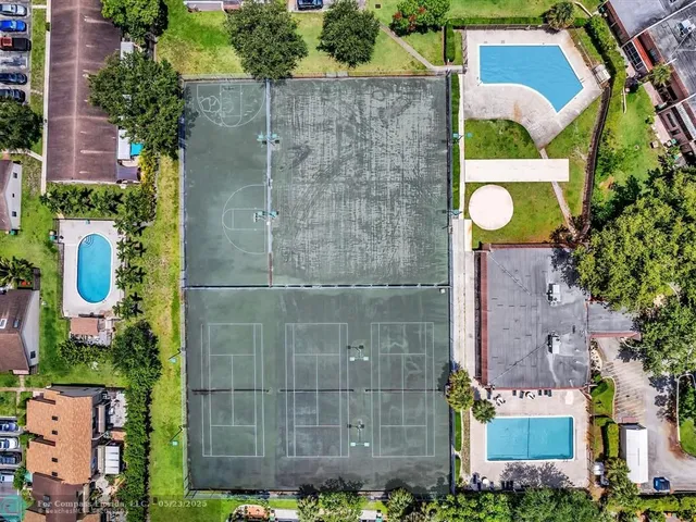 an aerial view of residential houses with outdoor space