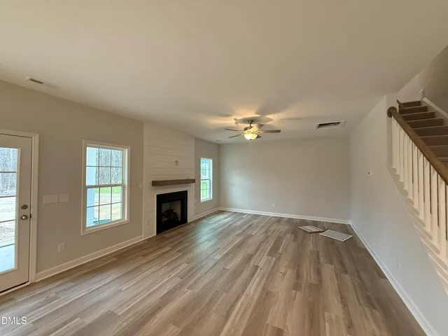 wooden floor in an empty room with a fireplace