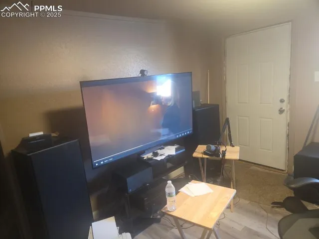 a workspace room with wooden floor and windows