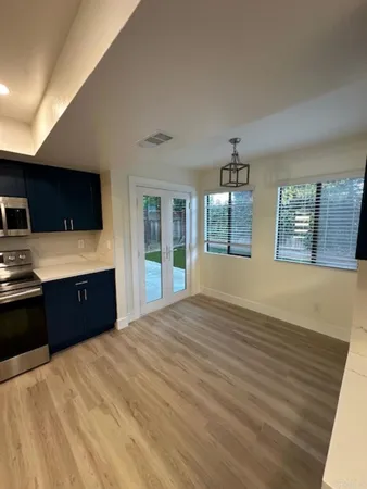 a large kitchen with kitchen island a sink dishwasher a refrigerator and a stove