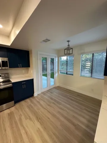 a large kitchen with kitchen island a sink dishwasher a refrigerator and a stove