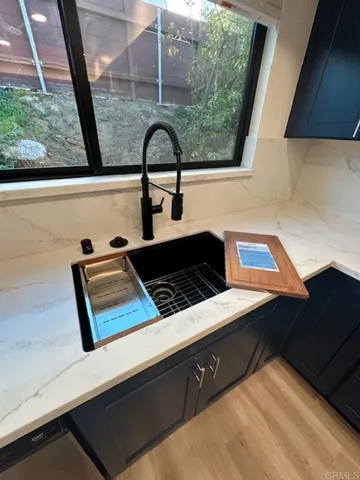 a large kitchen with stainless steel appliances kitchen island granite countertop a large counter top and a stove top oven