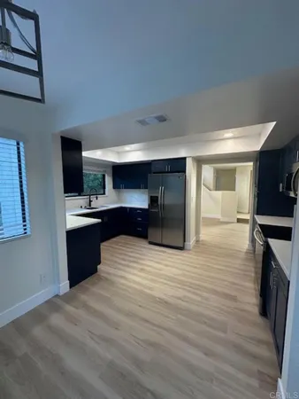 a kitchen with stainless steel appliances a sink and a refrigerator