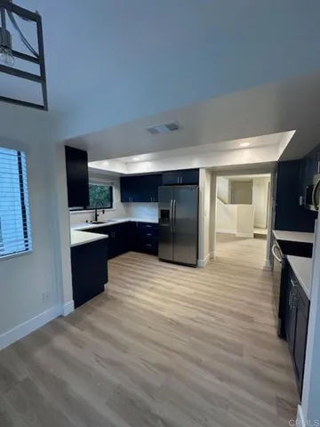 a kitchen with stainless steel appliances a sink and a refrigerator