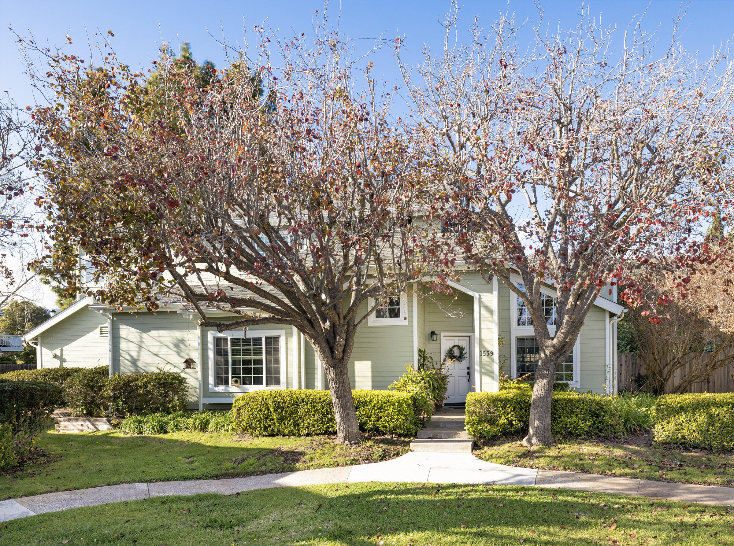 1539 Meadow Circle Carpinteria, CA 93013 - Photo 1 of 21 a front view of a house with a garden and trees
