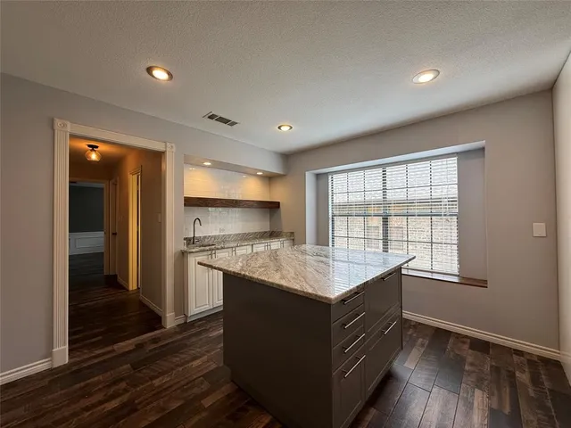 a kitchen with a sink stove and refrigerator