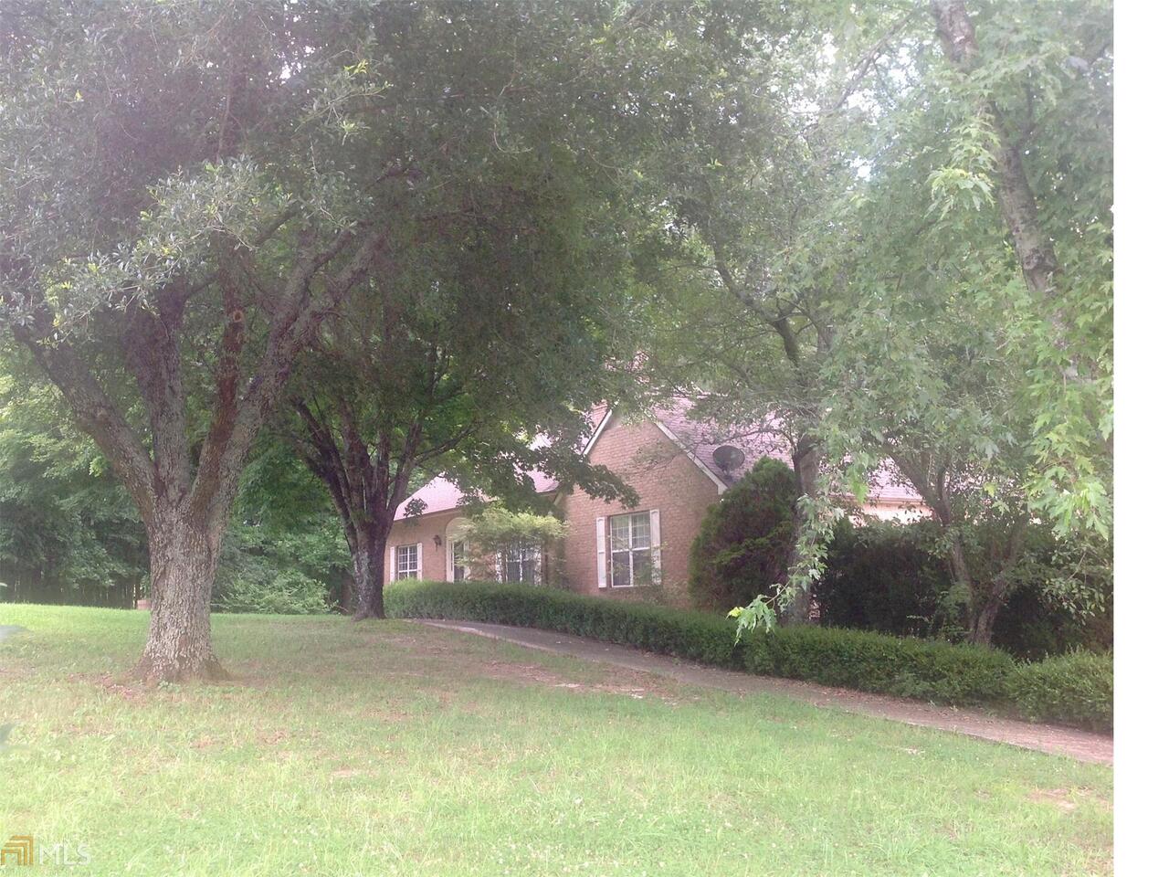 6316 Mt Zion Road Waco, GA 30182 - Photo 1 of 1 a front view of a house with a yard and garage