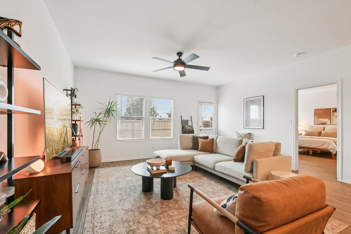117 Badillo Way Bastrop, TX 78602 - Photo 10 of 40 a living room with furniture a rug potted plant and a large window