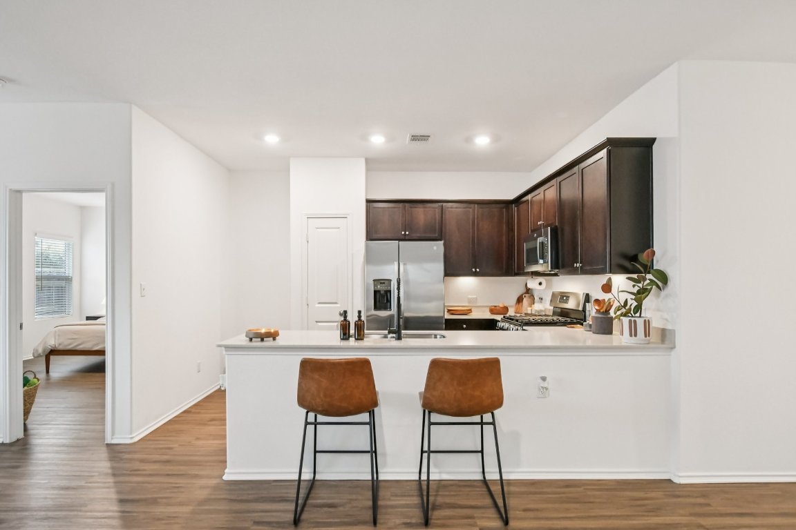 117 Badillo Way Bastrop, TX 78602 - Photo 15 of 40 a kitchen with stainless steel appliances granite countertop a sink and stove