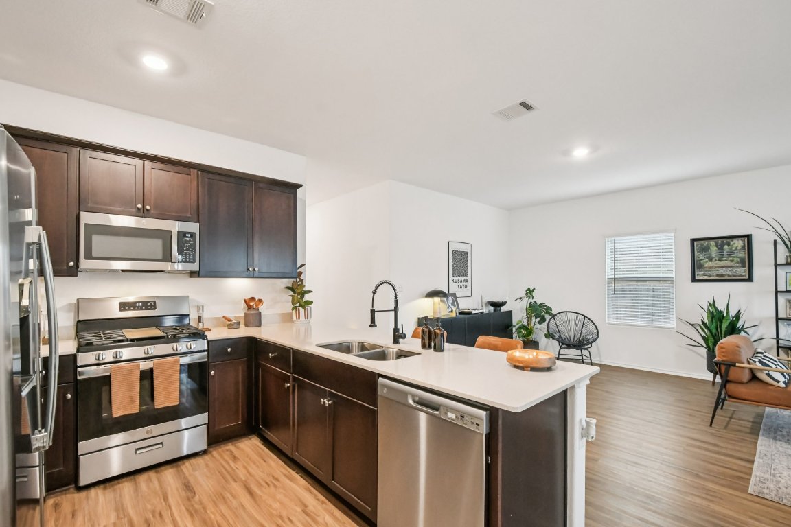117 Badillo Way Bastrop, TX 78602 - Photo 18 of 40 a kitchen with a sink stove and refrigerator