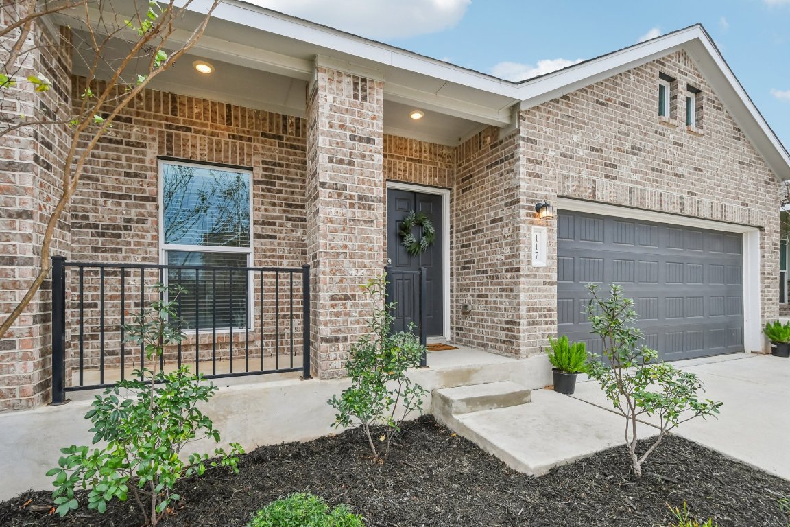 117 Badillo Way Bastrop, TX 78602 - Photo 4 of 40 a front view of a house with a garden