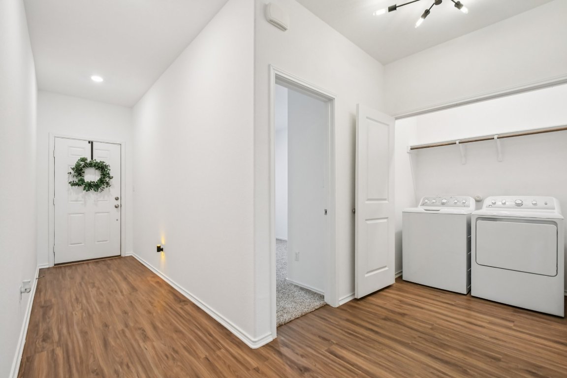 117 Badillo Way Bastrop, TX 78602 - Photo 5 of 40 a view of utility room with closet and wooden floor