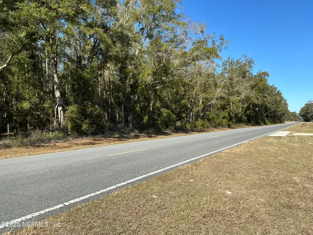 a view of a field and trees