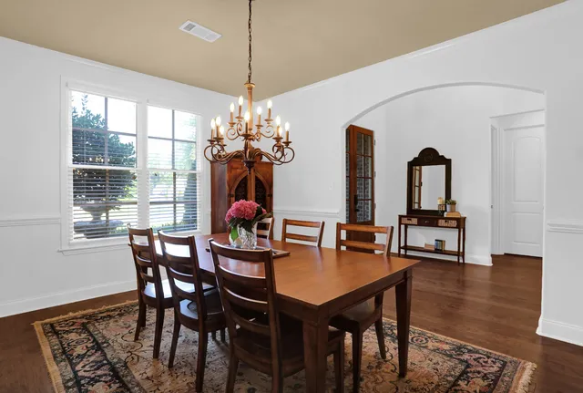 a kitchen with counter top space and dining table
