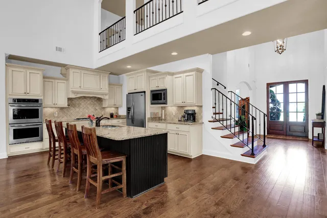 a kitchen with kitchen island granite countertop a center island and appliances