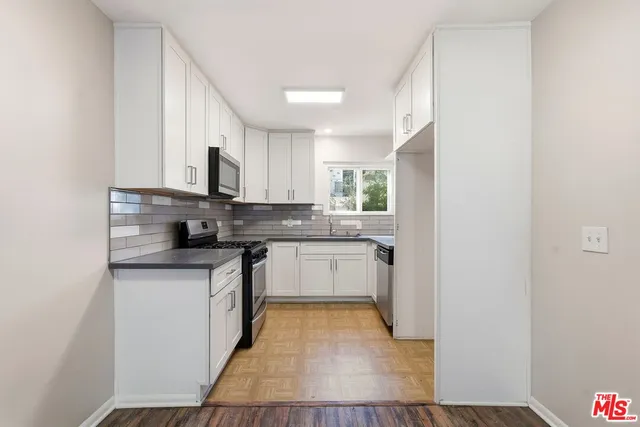 a view of an empty room and wooden floor