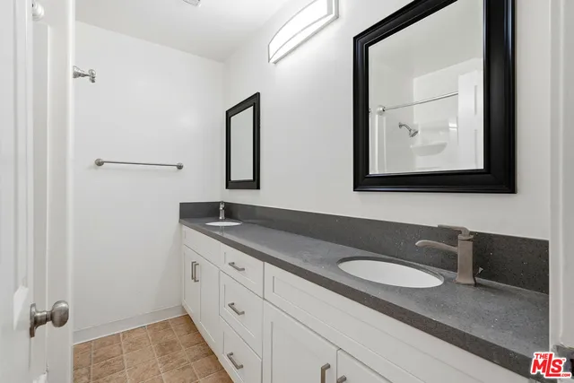 a front view of a house with a yard and a garden