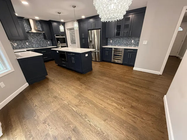 a kitchen with stainless steel appliances a sink microwave and stove