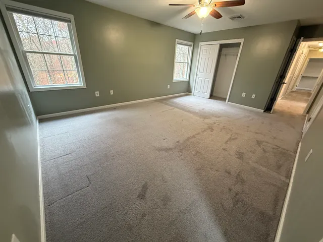 a bathroom with a sink a toilet a mirror and shower
