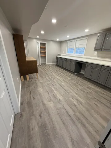 an empty room with wooden floor and mirror