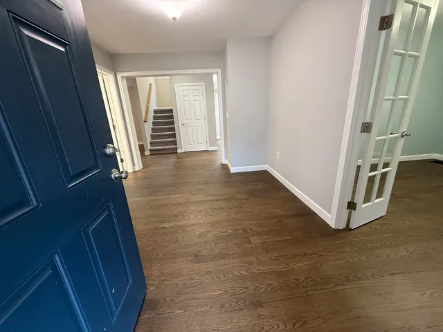 en empty room with wooden floor and window