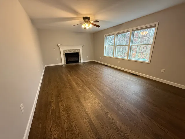 a kitchen with stainless steel appliances kitchen island granite countertop a refrigerator a sink dishwasher a stove and a dining table with wooden floor