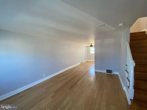 a view of wooden floor and staircase in a room