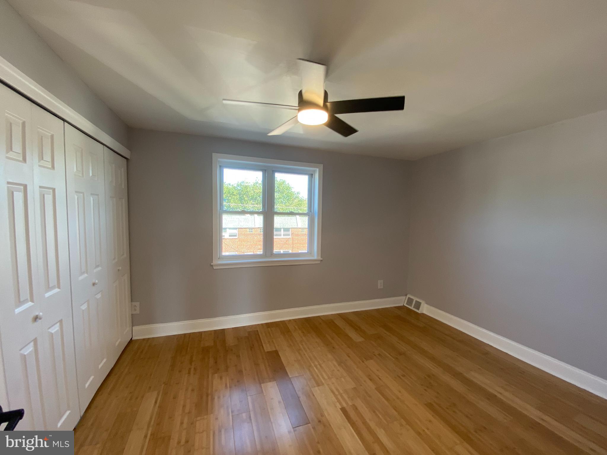 365 Ripka Street Philadelphia, PA 19128 - Photo 6 of 10 an empty room with wooden floor ceiling fan and windows