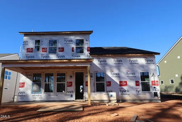 a view of street along with house and trees