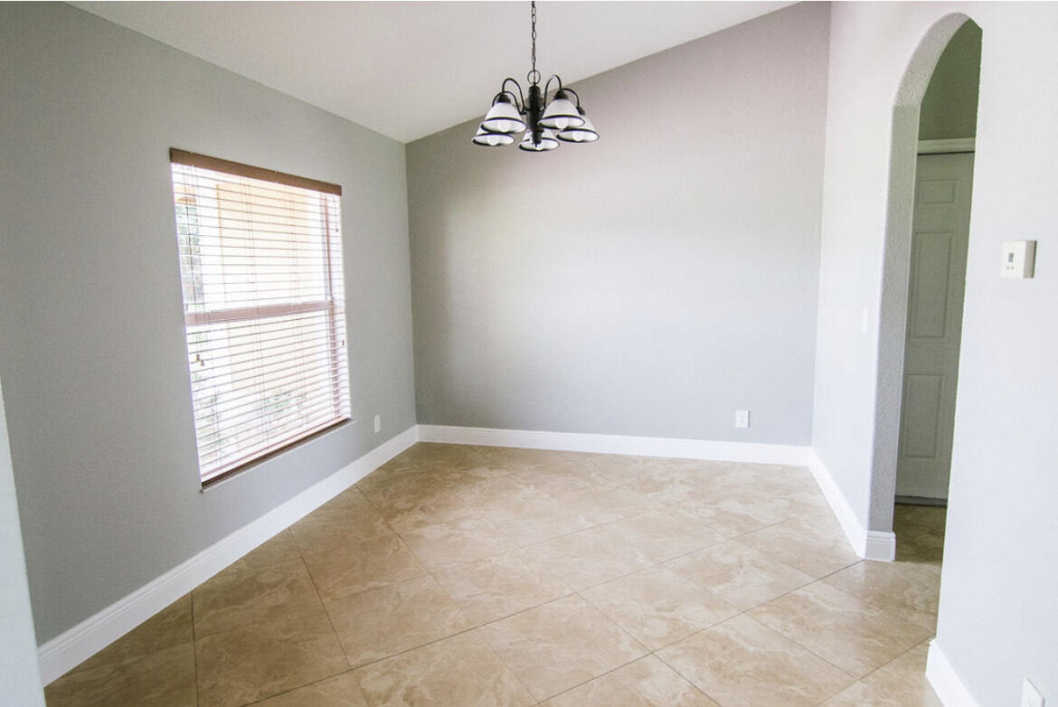 558 Southwest Colleen Avenue Port St. Lucie, FL 34983 - Photo 2 of 8 a view of an empty room with a window