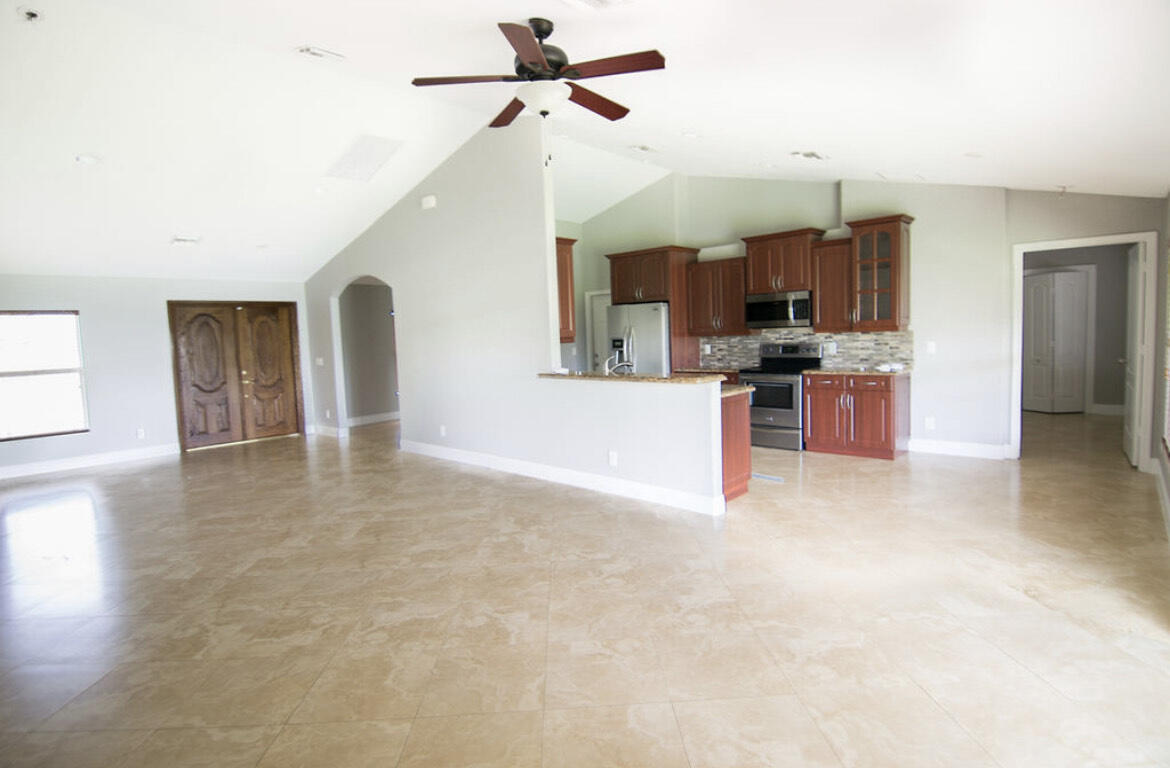 558 Southwest Colleen Avenue Port St. Lucie, FL 34983 - Photo 3 of 8 a view of kitchen with sink microwave and stove