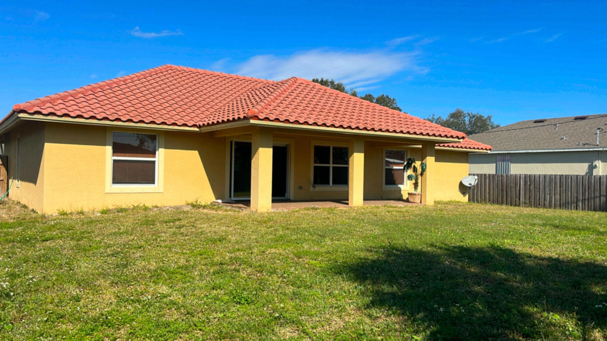 558 Southwest Colleen Avenue Port St. Lucie, FL 34983 - Photo 7 of 8 a front view of a house with a garden