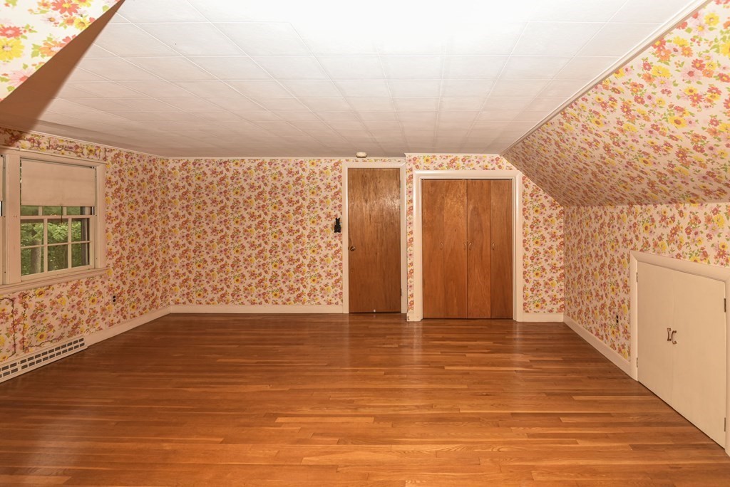 35 Old Post Road Walpole, MA 02032 - Photo 20 of 32 a view of an empty room with wooden floor and a window