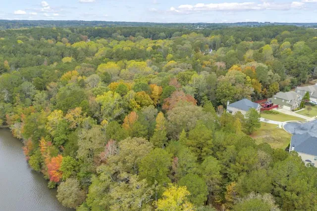 a view of a lake with houses in the back