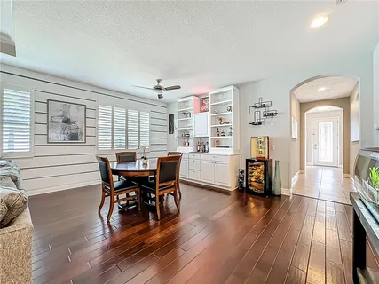 a view of a dining room with furniture and wooden floor