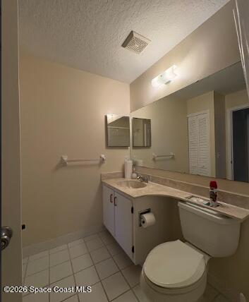 1927 Quail Ridge Court, Unit 1404 Cocoa, FL 32926 - Photo 15 of 23 a bathroom with a toilet a sink a mirror and vanity