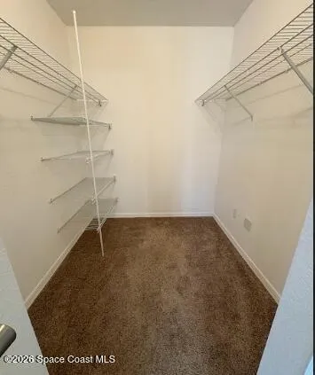 an empty room with windows and entrance