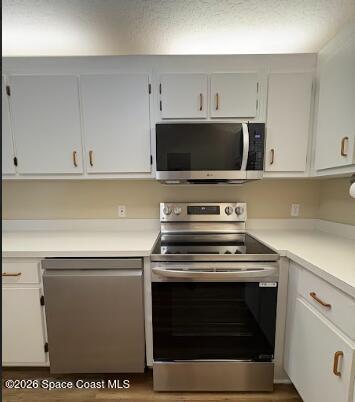1927 Quail Ridge Court, Unit 1404 Cocoa, FL 32926 - Photo 17 of 23 a kitchen with cabinets and appliances