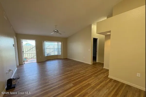 an empty room with closet and a chandelier fan