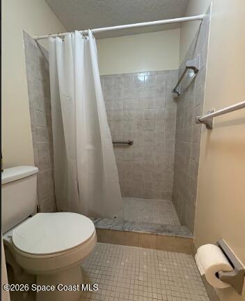 1927 Quail Ridge Court, Unit 1404 Cocoa, FL 32926 - Photo 10 of 23 a bathroom with a toilet and a shower