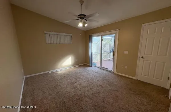 a view of a hallway with a chandelier fan and windows