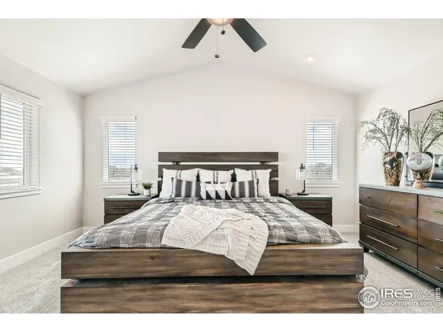 a bedroom with a bed and a large mirror