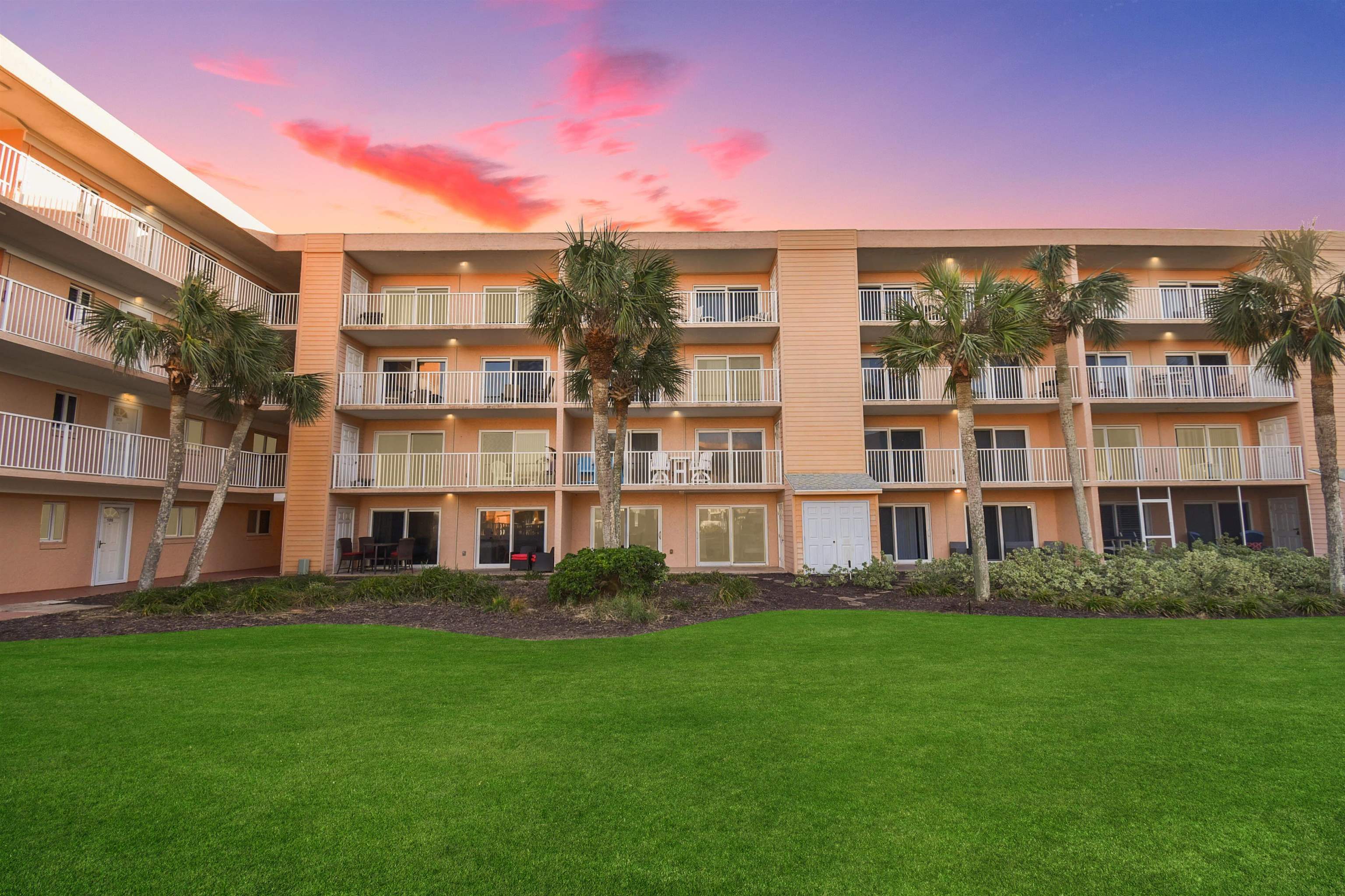 a front view of building with yard and green space