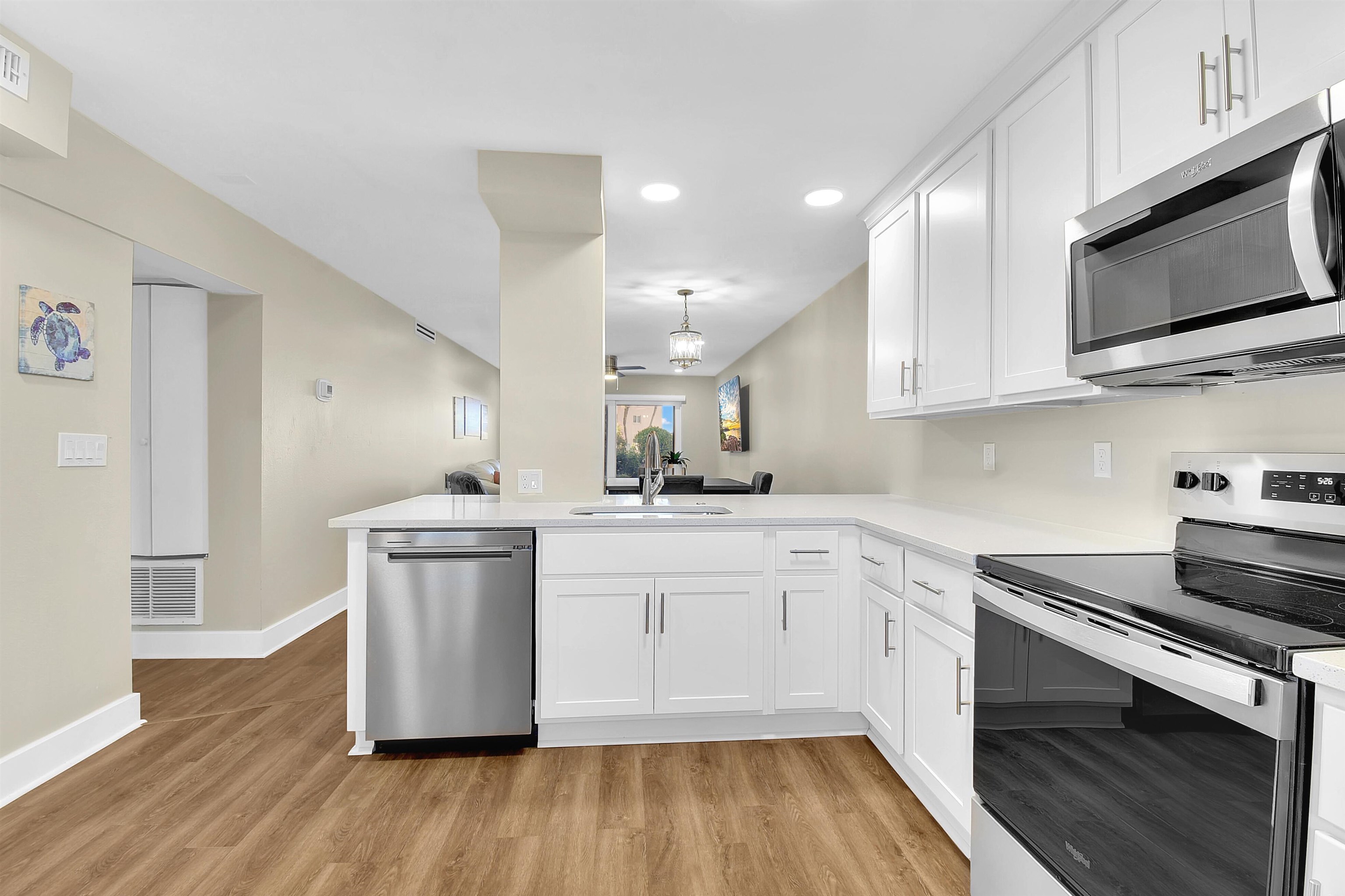 4 Ocean Trace Road, Unit 106 St. Augustine, FL 32080 - Photo 15 of 18 a kitchen with stainless steel appliances granite countertop a stove a sink and a microwave
