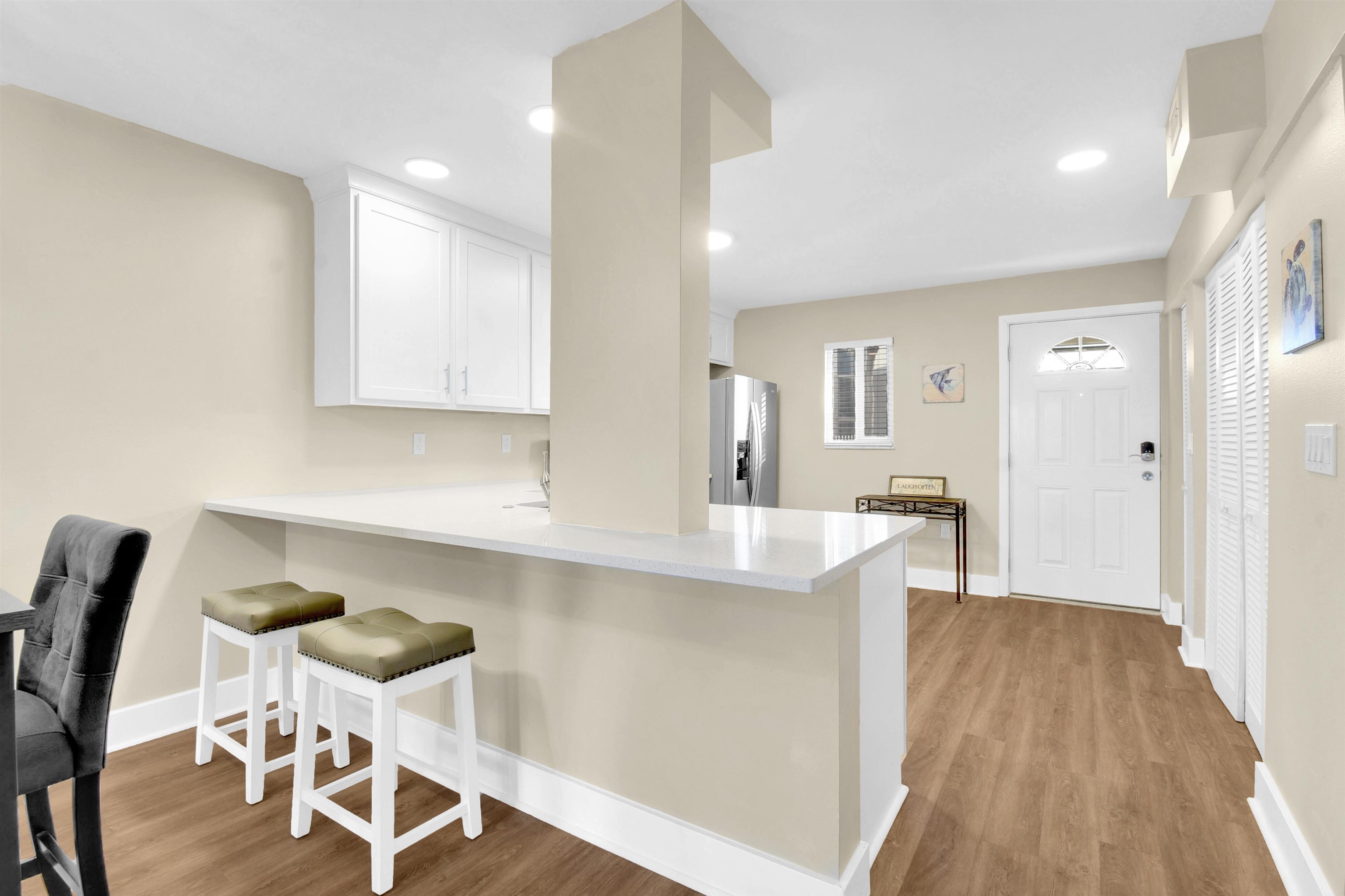 4 Ocean Trace Road, Unit 106 St. Augustine, FL 32080 - Photo 16 of 18 a view of a kitchen and dining area with chandelier