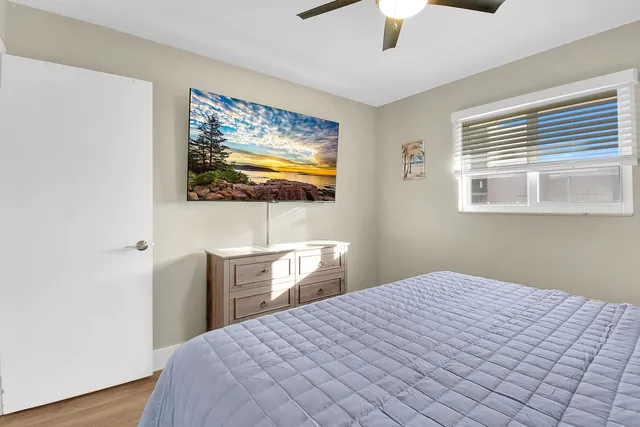 a bedroom with a bed and a view of wooden floor