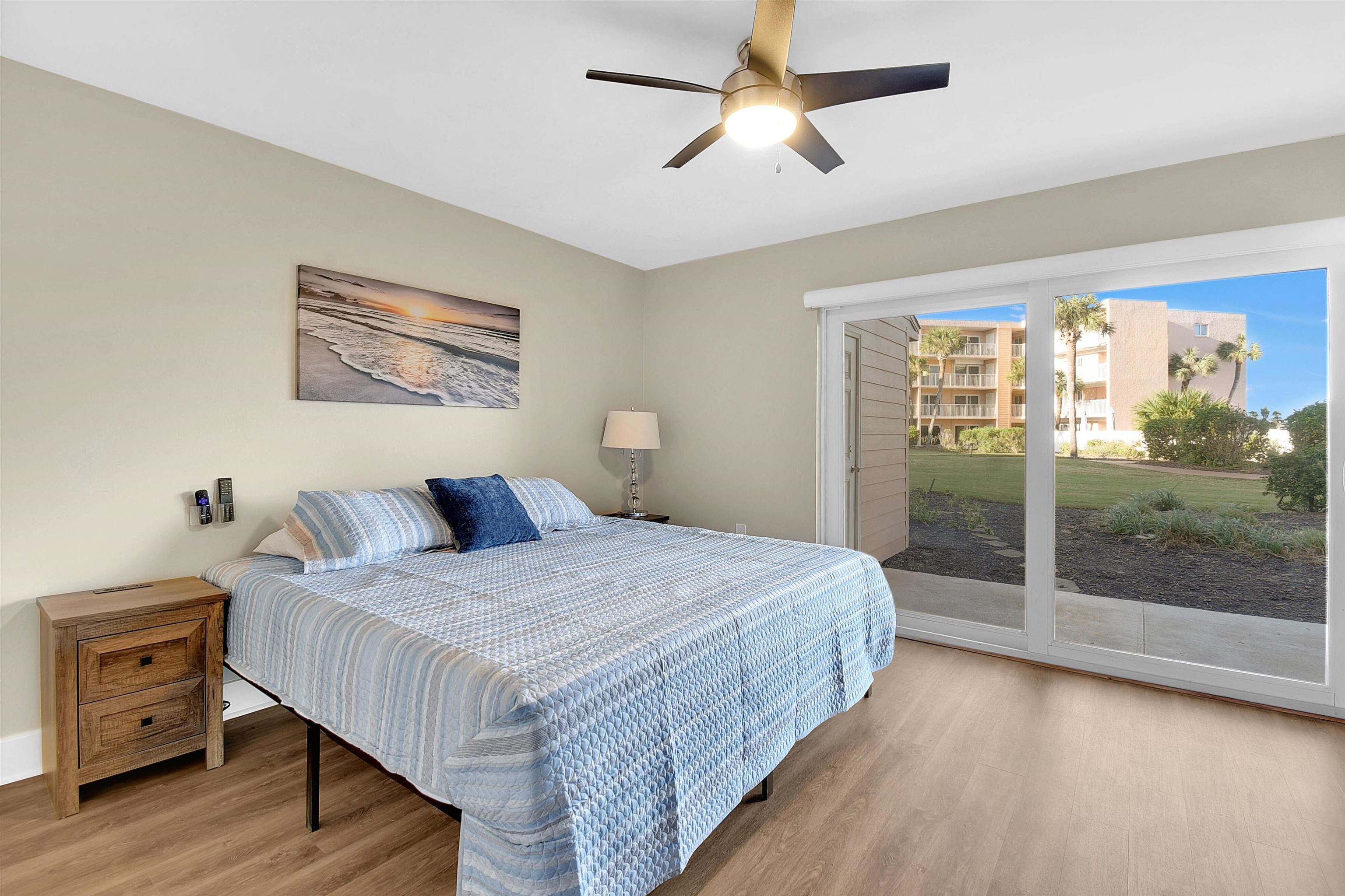 4 Ocean Trace Road, Unit 106 St. Augustine, FL 32080 - Photo 5 of 18 a bedroom with a large bed and a large window