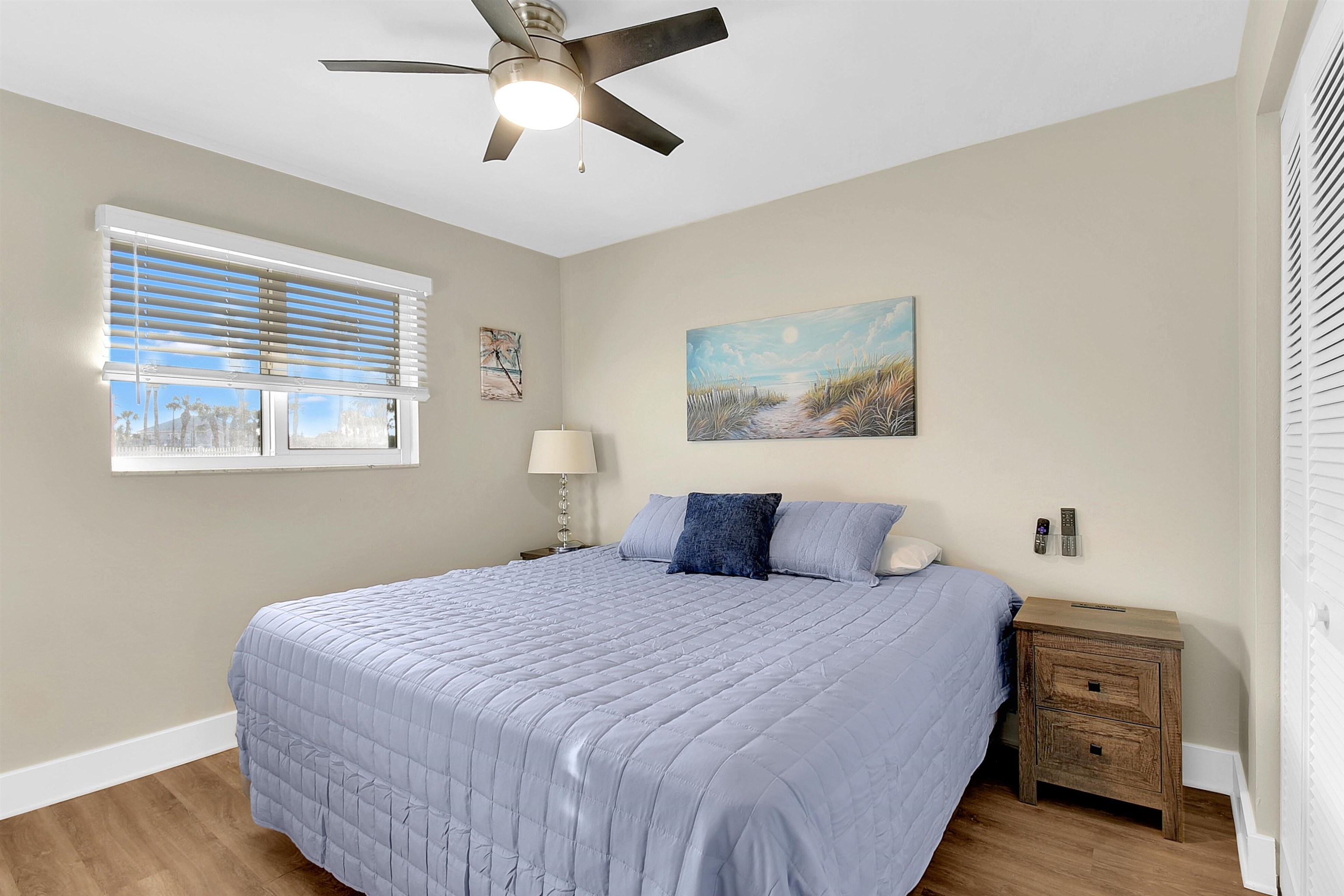 4 Ocean Trace Road, Unit 106 St. Augustine, FL 32080 - Photo 6 of 18 a bedroom with a bed and a chandelier